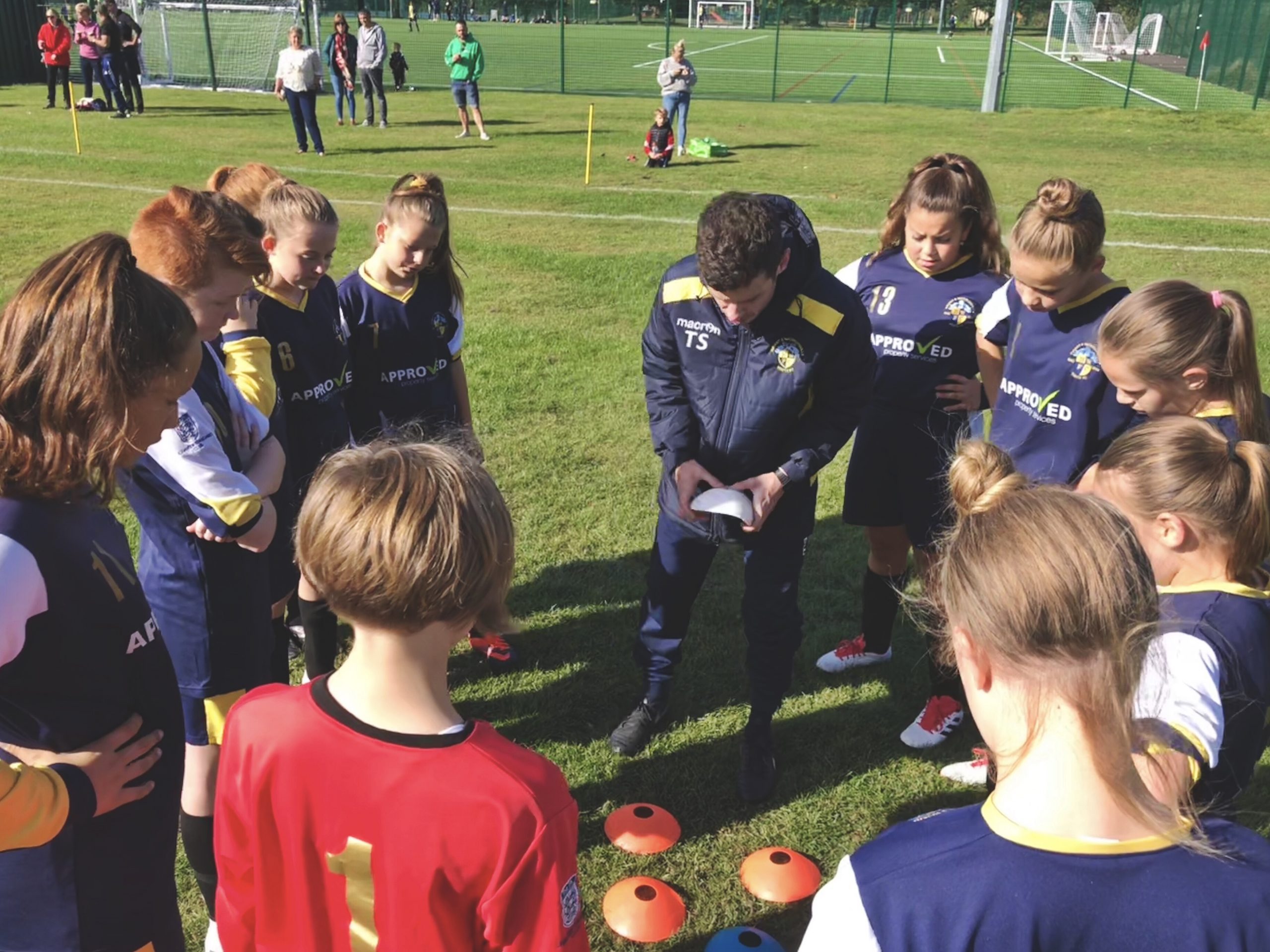 Thom Stone prepares the Havant & Waterlooville Girls for a match by demonstrating the formation they will be playing using cones.