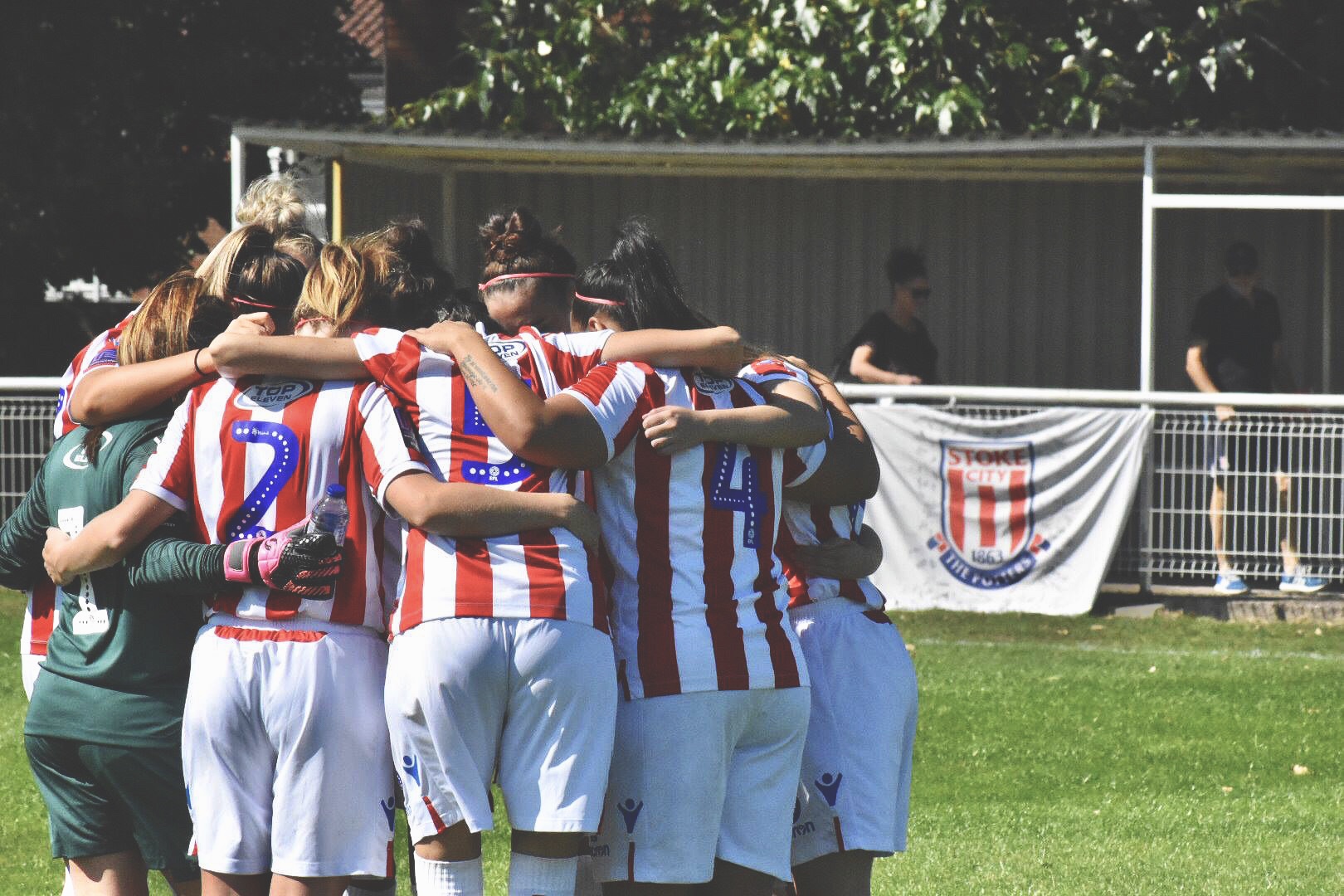 Stoke City Ladies huddle together for a pre match pep talk.