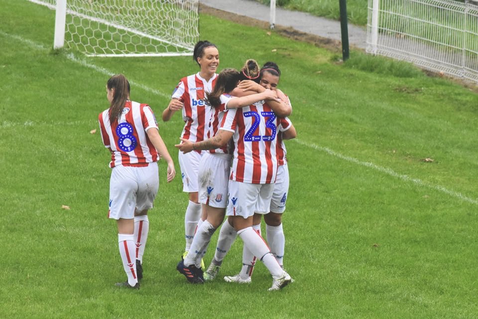 Faye is mobbed by her Stoke City team mates after scoring.