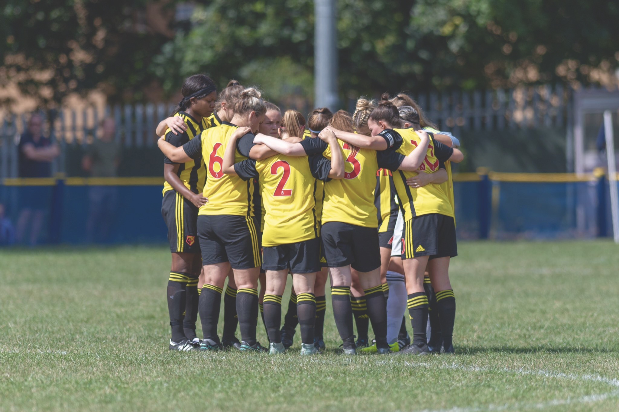 Watford FC Ladies in a group huddle. Taken by Andrew Waller Images.